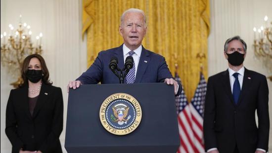 President Joe Biden speaks about the evacuation of American citizens, their families, SIV applicants and vulnerable Afghans in the East Room of the White House in Washington, on Friday. Vice-president Kamala Harris (left) and secretary of state Antony Blinken are also present. (AP)