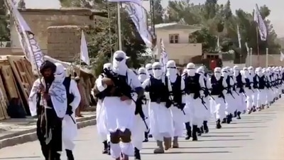 Taliban fighters march in uniforms on the street in Qalat, Zabul Province, Afghanistan, in this still image taken from social media video uploaded August 19, 2021, and obtained by REUTERS