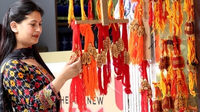 A woman looks at the rakhis hanged to buy ahead of the Raksha Bandhan festival, in Kullu on Saturday. (ANI Photo) A woman looks at the rakhis hanged to buy ahead of the Raksha Bandhan festival, in Kullu on Saturday. (ANI Photo)
