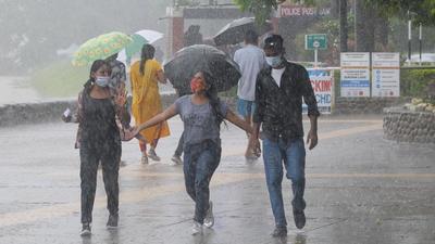 Residents enjoying the showers at Sukhna Lake in Chandigarh. The city recorded 20.8mm rain on Thursday. (Ravi Kumar//HT)