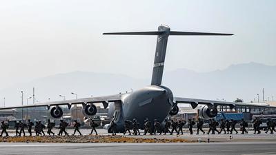 A group of 100-odd Indians, most of them employees of firms from Western countries, have been flown in US and NATO aircraft to Doha. This group too is expected to be brought back to India by Sunday. (REUTERS PHOTO.) A group of 100-odd Indians, most of them employees of firms from Western countries, have been flown in US and NATO aircraft to Doha. This group too is expected to be brought back to India by Sunday. (REUTERS PHOTO.)