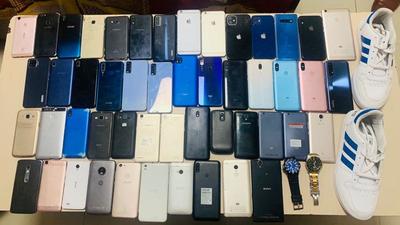 The phones, high-end watches and a pair of shoes recovered from the accused. (HT PHOTO) The phones, high-end watches and a pair of shoes recovered from the accused. (HT PHOTO)