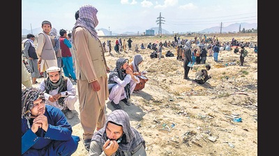Afghan people gather as they wait to board a U S military aircraft to leave the country, in Kabul. (AFP)