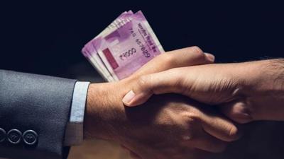 Businessmen making handshake in dark private room with money, Indian Rupee currency, in hands - bribery and corruption concept (Getty Images/iStockphoto) Businessmen making handshake in dark private room with money, Indian Rupee currency, in hands - bribery and corruption concept (Getty Images/iStockphoto)