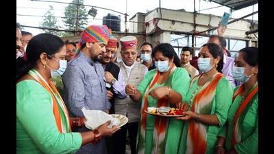 Women trying ‘Rakhi’ on Union minister Anurag Thakur’s wrist in Mandi on Saturday. (Birbal Sharma/HT)