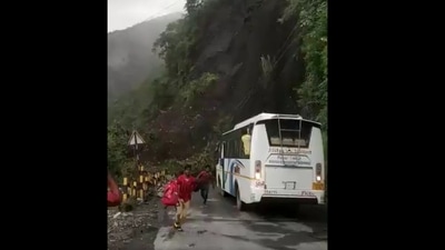 The passengers are seen running away from the landslide site in Nainital on Friday. (ANI Photo) The passengers are seen running away from the landslide site in Nainital on Friday. (ANI Photo)