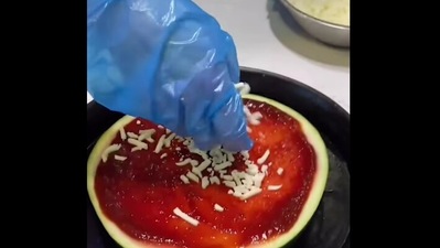 The image shows a watermelon pizza being made. (Instagram/@dominos.au)