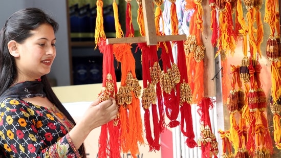 A woman shops for Rakhis ahead of Raksha Bandhan festival in Kullu, Himachal Pardesh. (Aqil Khan/Hindustan Times)