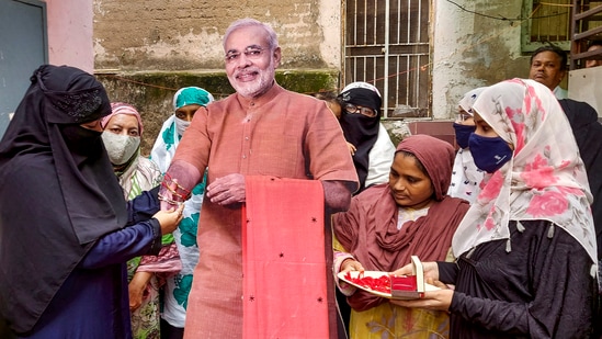 Muslim women tie Rakhi to a cut out of Prime Minister Narendra Modi ahead of Raksha Bandhan festival in Ahmedabad.(PTI)