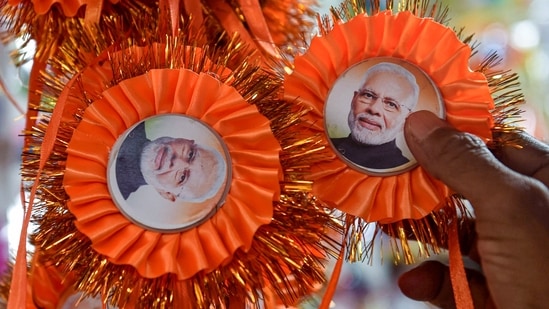 People buy rakhi with a photograph of the Prime Minister Narendra Modi ahead of Raksha Bandhan festival in Kolkata.(PTI)