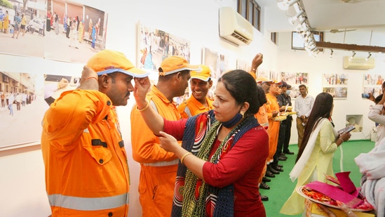 Women celebrate Raksha Bandhan with NDRF personnel, in Prayagraj. (PTI)
