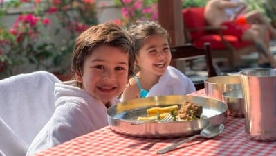 Kareena Kapoor Khan never fails to keep her fans updated with all her doings. From family get-togethers to vacations, she makes sure to treat them with pictures of all their celebrations. In this photo, Taimur Ali Khan and Inaaya Kemmu enjoy lunch together as they pause and smile for the camera. (Instagram/@kareenakapoorkhan)