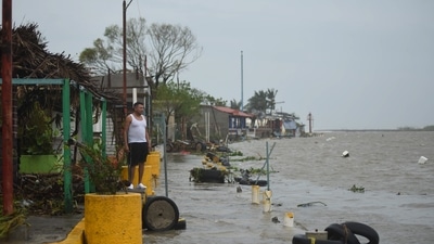 A resident surveys a flooded neighborhood after Hurricane Grace made landfall in Tecolitla, Veracruz state, Mexico, on Saturday, August 21. (Bloomberg) A resident surveys a flooded neighborhood after Hurricane Grace made landfall in Tecolitla, Veracruz state, Mexico, on Saturday, August 21. (Bloomberg)