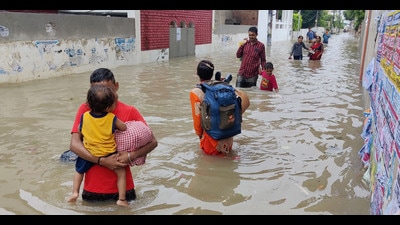 People wade through a flooded road after heavy downpour in Bathinda, Sunday (PTI) People wade through a flooded road after heavy downpour in Bathinda, Sunday (PTI)