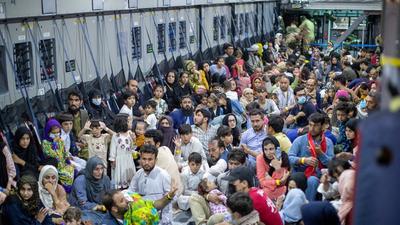 Evacuees from Afghanistan inside an Airbus A400 transport aircraft of the German Air Force Luftwaffe in Tashkent, Uzbekistan. (REUTERS)