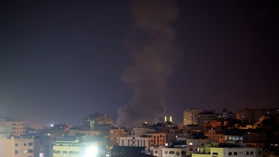 Explosions light up the night sky above buildings in Gaza City as Israeli forces shell the Palestinian enclave, early on August 22, 2021. (AFP) Explosions light up the night sky above buildings in Gaza City as Israeli forces shell the Palestinian enclave, early on August 22, 2021. (AFP)