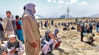 Afghan people gather as they wait to board a U S military aircraft to leave the country, in Kabul. (AFP) Afghan people gather as they wait to board a U S military aircraft to leave the country, in Kabul. (AFP)