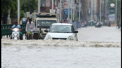 Motorists wade through a waterlogged road at Bathinda on Sunday. Motorists wade through a waterlogged road at Bathinda on Sunday.