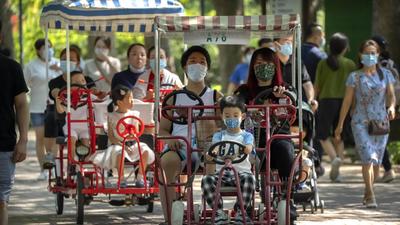 Adults and children ride pedal cycles at a park in Beijing, China, on Saturday (AP) Adults and children ride pedal cycles at a park in Beijing, China, on Saturday (AP)