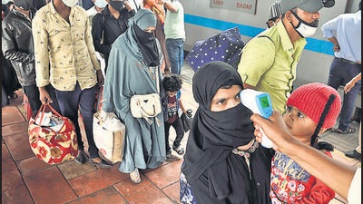 A BMC health worker checks temperature before Covid-19 test of commuters arriving from outstation trains at Dadar station. (Satish Bate/HT Photo) A BMC health worker checks temperature before Covid-19 test of commuters arriving from outstation trains at Dadar station. (Satish Bate/HT Photo)