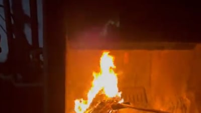 A video grab of the principal setting ablaze to all documents of her students that she said was for their safety. (Twitter@sbasijrasikh)