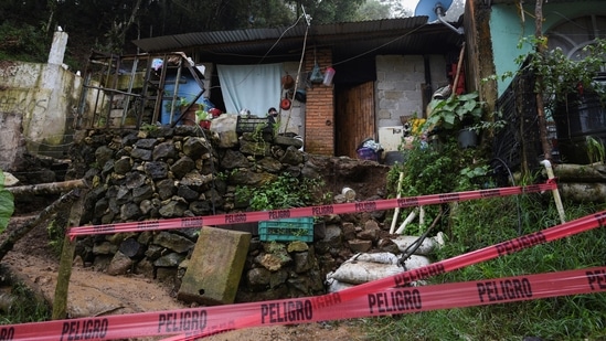 Red tape blocks the access to a house where several people were killed in a mudslide after Hurricane Grace pummeled Mexico with torrential rain on Saturday, August 21.(REUTERS)