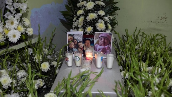 Photographs of the Moreno family are seen on a makeshift altar, after a landslide buried their home during the passage of Hurricane Grace, in Xalapa, Veracruz State in Mexico, on Saturday, August 21.(AP)