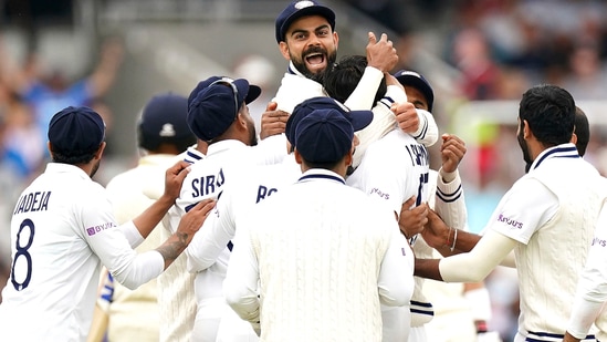 India's Virat Kohli, top, celebrates with teammates.(AP)
