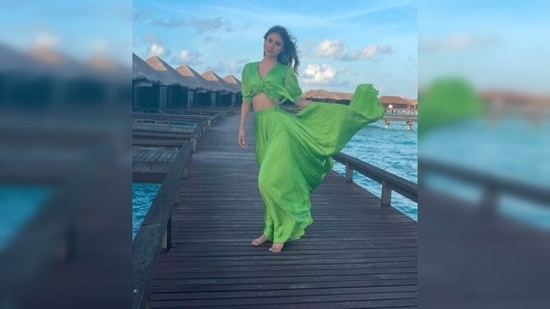 A few days ago, Mouni Roy made jaws drop when she styled herself in a green blouse and skirt and posed in front of a picturesque backdrop.(Instagram/@mouniroy)