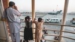 Children point at an aircraft at Hamid Karzai International Airport in Kabul.