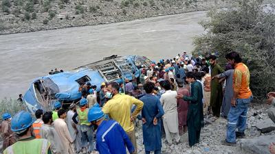 Residents and rescue workers gather at the site of bus accident, in Kohistan district of Pakistan’s Khyber Pakhtunkhwa province, on July 14, 2021. (AP) Residents and rescue workers gather at the site of bus accident, in Kohistan district of Pakistan’s Khyber Pakhtunkhwa province, on July 14, 2021. (AP)