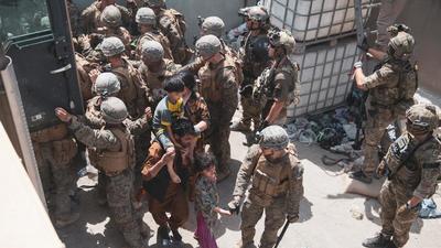 US Marines and Norwegian coalition forces assist with security at a checkpoint ensuring evacuees are processed safely during an evacuation at Hamid Karzai International Airport, Kabul, in Afghanistan. (REUTERS) US Marines and Norwegian coalition forces assist with security at a checkpoint ensuring evacuees are processed safely during an evacuation at Hamid Karzai International Airport, Kabul, in Afghanistan. (REUTERS)