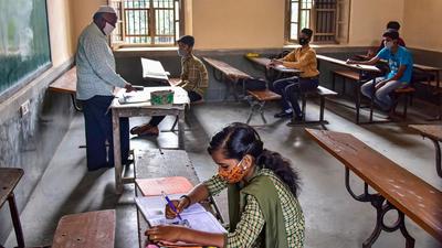 Students attend a class as the Karnataka Government allowed to reopen the schools to conduct the classes for 9th-10th and pre-university college in Bengaluru on Monday. (PTI) Students attend a class as the Karnataka Government allowed to reopen the schools to conduct the classes for 9th-10th and pre-university college in Bengaluru on Monday. (PTI)