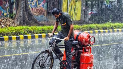 A man rides amid heavy rainfall, in New Delhi on August 20. (File photo)