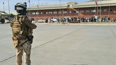 Soldiers on the tarmac waiting for passengers, who fled Afghanistan, to board on an military aircraft at Kabul airport. (AFP) Soldiers on the tarmac waiting for passengers, who fled Afghanistan, to board on an military aircraft at Kabul airport. (AFP)