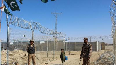 An Afghan boy walks by the fences guarded by the Pakistani paramilitary personnel at the Pakistan-Afghanistan border crossing point in Chaman, following Taliban's military takeover of Afghanistan. (AFP)
