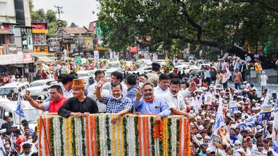Dehradun: Delhi Chief Minister Arvind Kejriwal with Aam Aadmi Party's chief ministerial candidate for Uttarakhand elections, retired Col. Ajay Kothiyal during 'Devbhoomi Sankalp Yatra', in Dehradun, on Aug 17, 2021. (PTI) Dehradun: Delhi Chief Minister Arvind Kejriwal with Aam Aadmi Party's chief ministerial candidate for Uttarakhand elections, retired Col. Ajay Kothiyal during 'Devbhoomi Sankalp Yatra', in Dehradun, on Aug 17, 2021. (PTI)