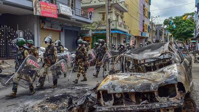 On August 11 last year, an angry mob, enraged over an alleged derogatory social media post shared by Srinivasamurthy’s nephew, burnt down more than 60 vehicles as well as DJ Halli and KG Halli police stations in Bengaluru apart from the house of the MLA. The violence claimed four lives and left several injured. (PTI) On August 11 last year, an angry mob, enraged over an alleged derogatory social media post shared by Srinivasamurthy’s nephew, burnt down more than 60 vehicles as well as DJ Halli and KG Halli police stations in Bengaluru apart from the house of the MLA. The violence claimed four lives and left several injured. (PTI)