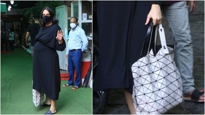 Neha Dhupia accessorised her look with a black and white tote bag and black mask. (HT Photo/Varinder Chawla)