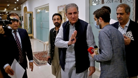 Pakistan's foreign minister Shah Mahmood Qureshi waves after leaving a press conference on Afghanistan, in Islamabad, Pakistan on Monday, Qureshi on Monday urged the Taliban and other Afghan leaders to try to reach an understanding for an inclusive political settlement as soon as possible so that an uncertain situation prevailing in Afghanistan ends. (AP)