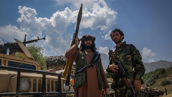 Afghan armed men supporting the Afghan security forces against the Taliban stand with their weapons and Humvee vehicles in Panjshir province.(AFP Photo)