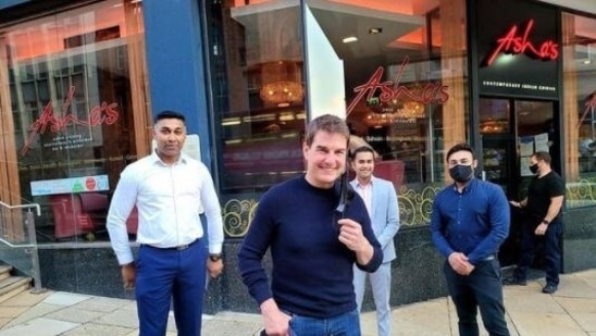 Tom Cruise poses for a picture outside Asha Bhosle's UK restaurant.