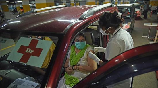 A beneficiary gets inoculated against Covid-19 at a drive-in vaccination centre at Inorbit Mall basement parking, Vashi, in Navi Mumbai on Monday. (Bachchan Kumar/ HT PHOTO)