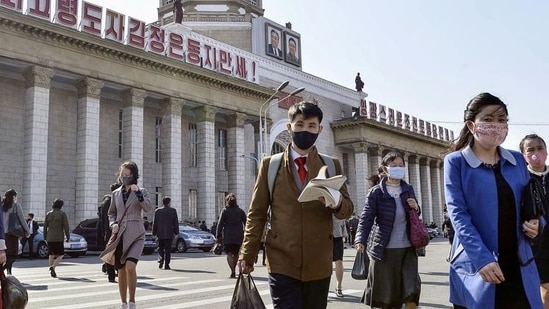 People wearing protective face masks walk amid concerns over the coronavirus disease (Covid-19) in front of Pyongyang Station in Pyongyang, North Korea(via Reuters) People wearing protective face masks walk amid concerns over the coronavirus disease (Covid-19) in front of Pyongyang Station in Pyongyang, North Korea(via Reuters)