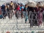 Afghans walk along fences as they arrive in Pakistan through the border crossing point in Chaman following the Taliban's military takeover of Afghanistan. Afghans walk along fences as they arrive in Pakistan through the border crossing point in Chaman following the Taliban's military takeover of Afghanistan.