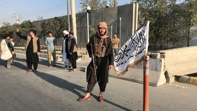 A Taliban fighter stands outside the interior ministry in Kabul, (Reuters File Photo)