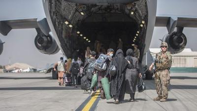 Families begin to board a US Air Force Boeing C-17 Globemaster III aircraft during an evacuation operation at Hamid Karzai International Airport in Kabul, Afghanistan on August 23, 2021. (AFP) Families begin to board a US Air Force Boeing C-17 Globemaster III aircraft during an evacuation operation at Hamid Karzai International Airport in Kabul, Afghanistan on August 23, 2021. (AFP)