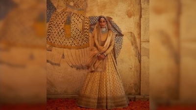 Masaba Gupta is the epitome of elegance and royalty in this traditional beige bridal lehenga by designer Sabyasachi Mukherjee. (Instagram/@sabyasachiofficial) Masaba Gupta is the epitome of elegance and royalty in this traditional beige bridal lehenga by designer Sabyasachi Mukherjee. (Instagram/@sabyasachiofficial)