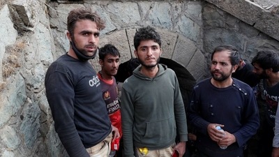 Muhammad Ali, an Afghan migrant from Khost who planned to found his own cryptocurrency mining business, center, and the other migrants hide from security forces after crossing illegally into Turkey from Iran, near Tatvan in Bitlis province, Turkey, on August 23, 2021. (REUTERS)