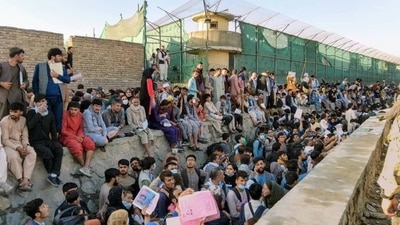 Crowds of people wait outside the airport in Kabul, Afghanistan. (REUTERS)
